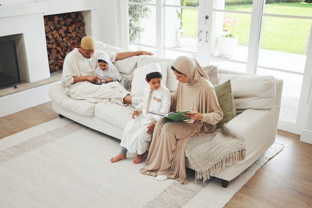 Quran, Muslim parents or children reading for learning, Islamic knowledge or studying in Allah, god